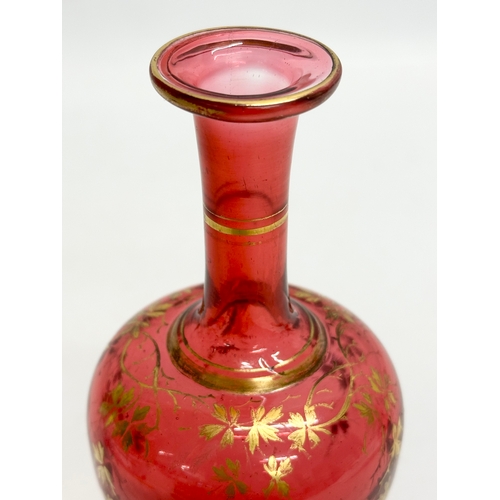 217 - A Late 19th Century Bohemian, Moser style cranberry glass bottle vase, with hand painted gilt leaves... 