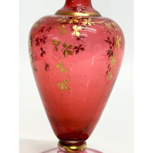 217 - A Late 19th Century Bohemian, Moser style cranberry glass bottle vase, with hand painted gilt leaves... 