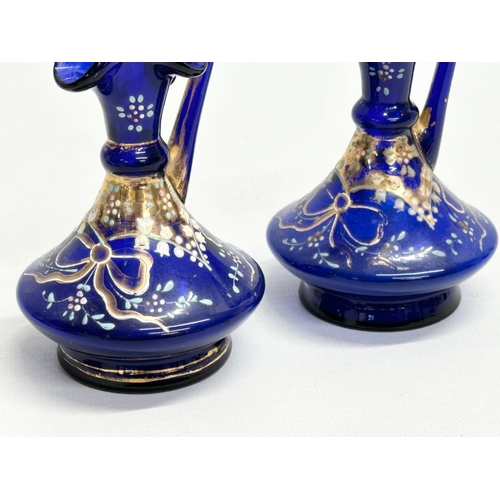 218 - A pair of small Late 19th Century Bristol Blue glass ewers. 10.5cm