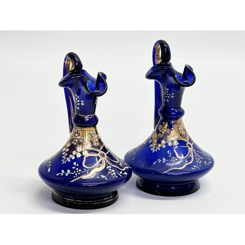 218 - A pair of small Late 19th Century Bristol Blue glass ewers. 10.5cm