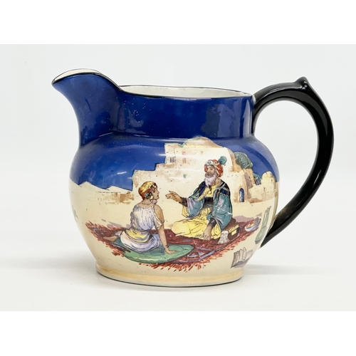 236 - An Early 20th Century Britannia Pottery Omar Khayyam jug. 17x13x12cm.