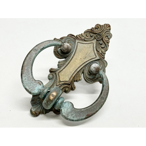 243 - A Late 19th Century door knocker, together with an Early/Mid 20th Century Italian door knocker. 21cm... 