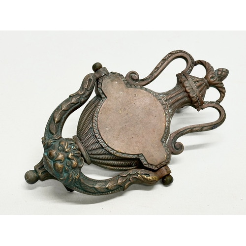 243 - A Late 19th Century door knocker, together with an Early/Mid 20th Century Italian door knocker. 21cm... 