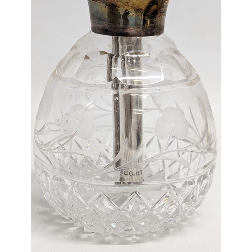 498 - An early 20th century silver topped perfume bottle by 	Charles S Green & Co Ltd. Birmingham, 1923. 1... 