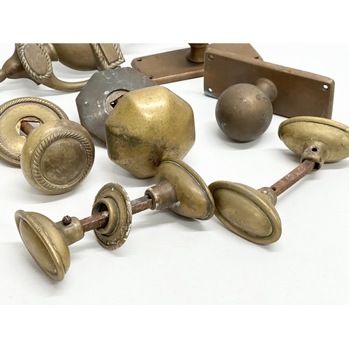 245 - A collection of Victorian brass door handles and a later door knocker.