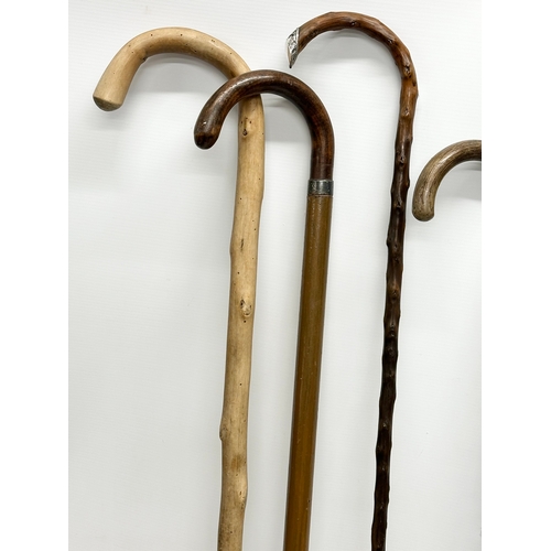 248 - A collection of vintage walking sticks. Including 1 silver mounted.