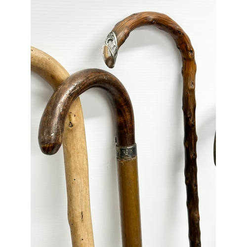 248 - A collection of vintage walking sticks. Including 1 silver mounted.