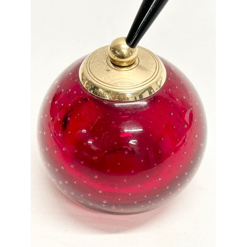 240 - A Whitefriars ruby glass paperweight pen holder by Parker.