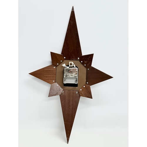 190 - A Mid Century teak sunburst clock. Acctim. 40x64cm