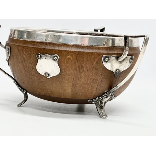 543 - An Early 20th Century oak trophy bowl with silver plated mounts. Circa 1910. 29x28x13cm.