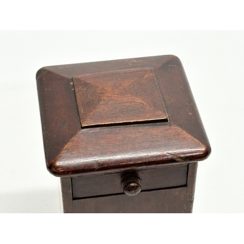 546 - An Edwardian mahogany puzzle box/money box. 11x11x20cm.