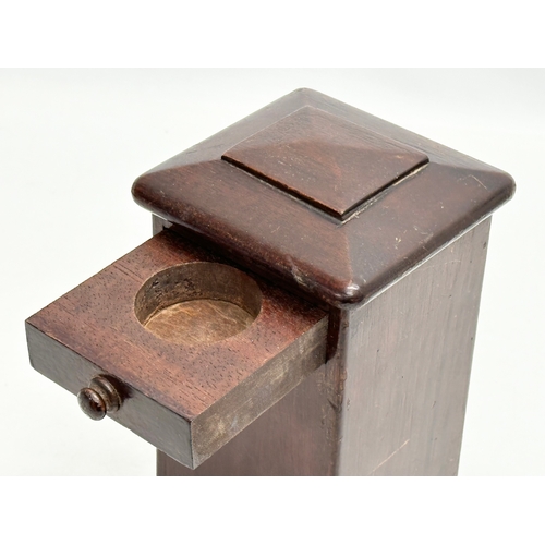 546 - An Edwardian mahogany puzzle box/money box. 11x11x20cm.