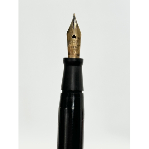 401A - A 14k gold nib. An Early 20th Century fountain pen desk set on marble stand. 25cm