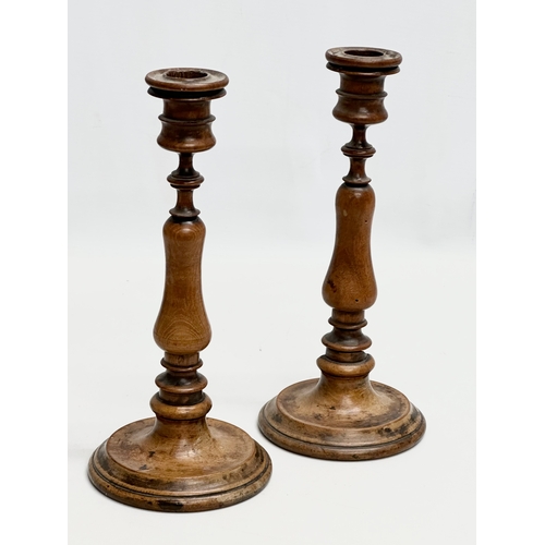 556 - A pair of Late 19th Century Victorian turned pearwood/fruitwood candlsticks. 26cm