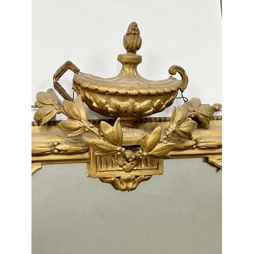 23 - An Early 19th Century Regency gilt framed girandole mirror. Circa 1810. 57x102cm