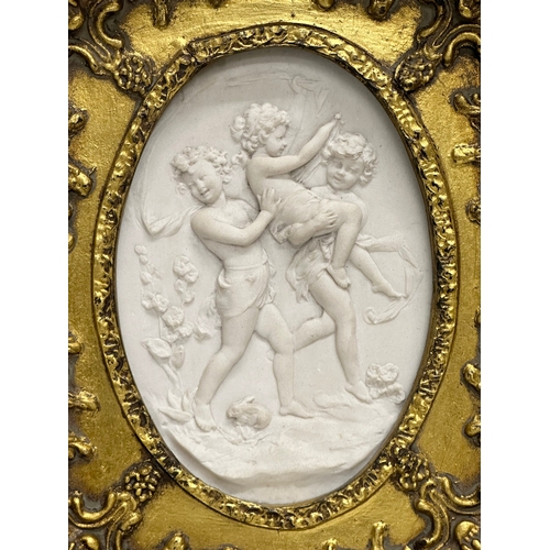 262 - A set of 4 Late 20th Century gilt framed wall plaques with carved cherub panels. Marked P.T. Seymour... 