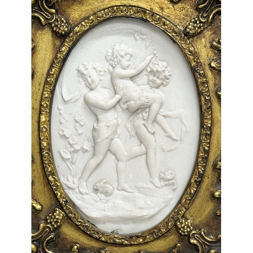 262 - A set of 4 Late 20th Century gilt framed wall plaques with carved cherub panels. Marked P.T. Seymour... 