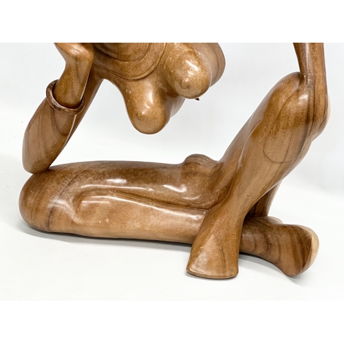 570 - A large carved Indonesian rosewood sculpture. 47x51cm.