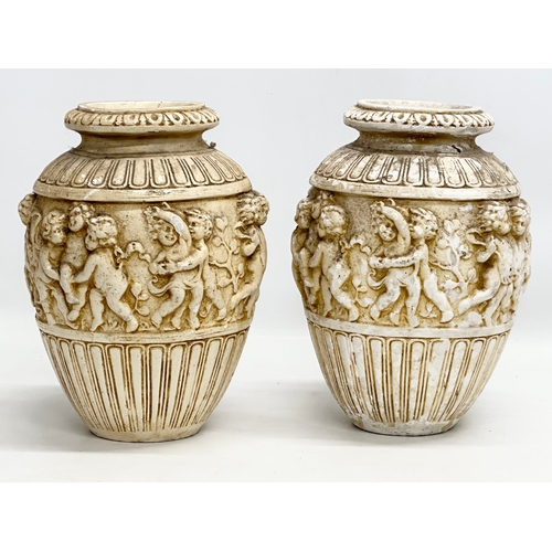 574 - A pair of Mid 20th Century moulded relief cherub vases. 21x30cm