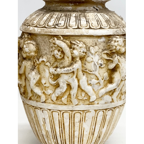 574 - A pair of Mid 20th Century moulded relief cherub vases. 21x30cm