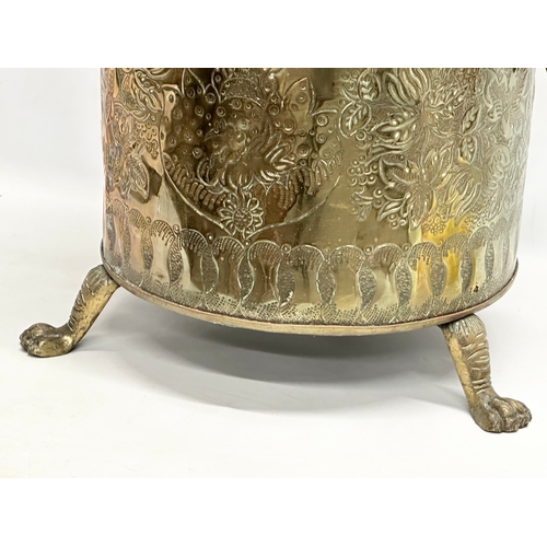 42 - A large Late 19th Century Victorian brass and copper coal bin. Raised on 3 brass lion paw feet. Circ... 