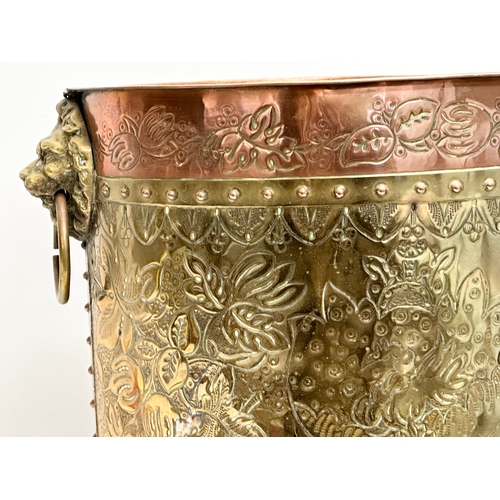 42 - A large Late 19th Century Victorian brass and copper coal bin. Raised on 3 brass lion paw feet. Circ... 