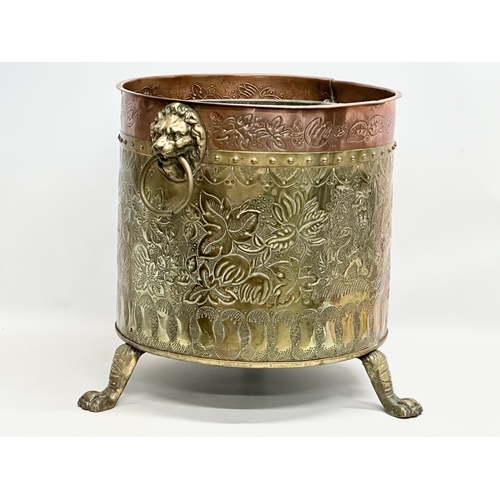 42 - A large Late 19th Century Victorian brass and copper coal bin. Raised on 3 brass lion paw feet. Circ... 