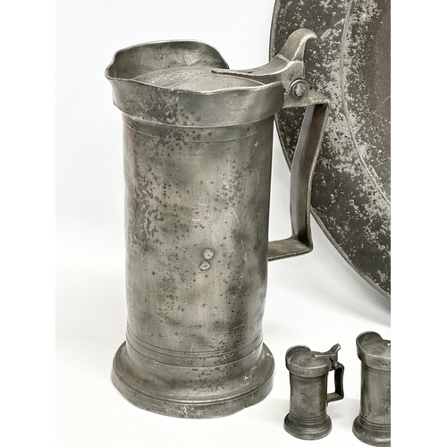 279 - A collection of 19th Century French pewter. 7 pewter measures/tankards and a pewter tray. Largest me... 