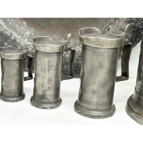 279 - A collection of 19th Century French pewter. 7 pewter measures/tankards and a pewter tray. Largest me... 