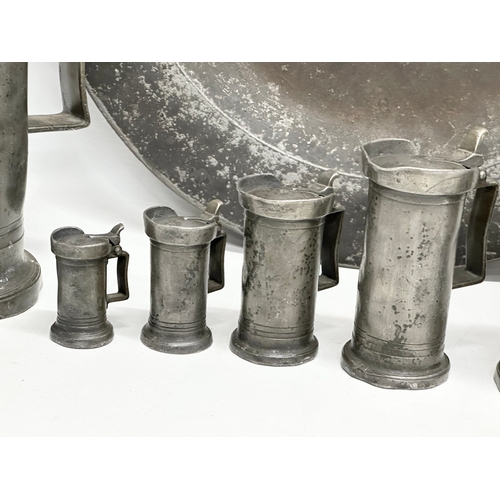 279 - A collection of 19th Century French pewter. 7 pewter measures/tankards and a pewter tray. Largest me... 