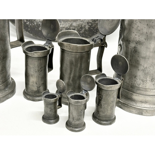 279 - A collection of 19th Century French pewter. 7 pewter measures/tankards and a pewter tray. Largest me... 