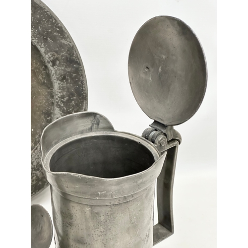 279 - A collection of 19th Century French pewter. 7 pewter measures/tankards and a pewter tray. Largest me... 