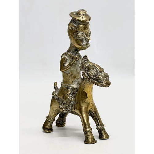 296 - A Late 19th Century African brass rider and bird. 21cm. 18cm.