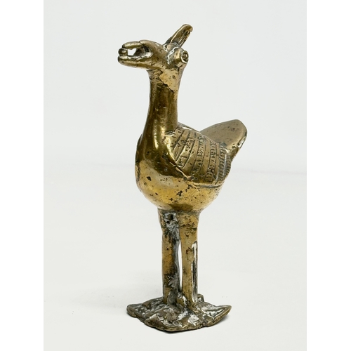 296 - A Late 19th Century African brass rider and bird. 21cm. 18cm.