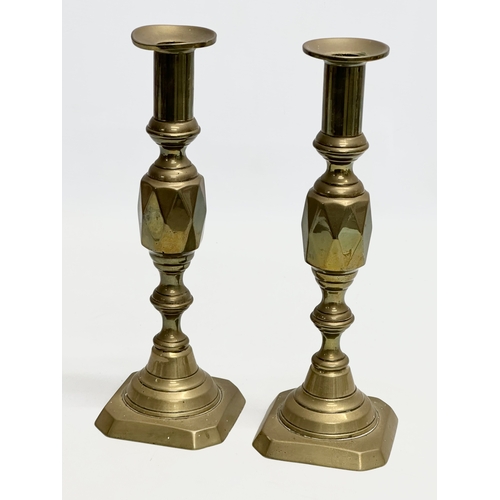 634 - Two pairs of Victorian brass candlesticks. 29cm. 27cm.