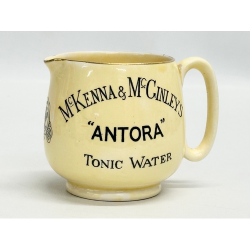 405A - A rare J. A. Campbell & Son McKenna & McGinley’s Model Orange “Antora” Tonic Water jug. 10x7.5x8cm.