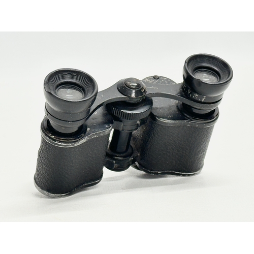 671 - A pair of Early/Mid 20th Century binoculars with original leather case.