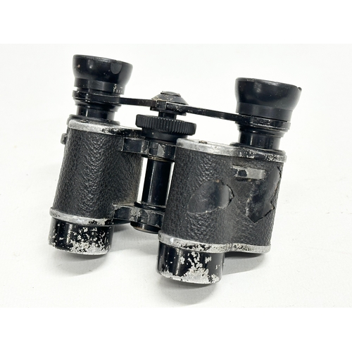 671 - A pair of Early/Mid 20th Century binoculars with original leather case.