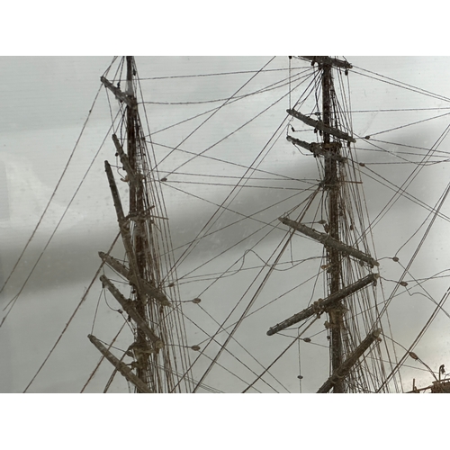 208 - A large 19th Century model ship on display case. 73x30.5x53cm.