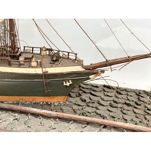 208 - A large 19th Century model ship on display case. 73x30.5x53cm.