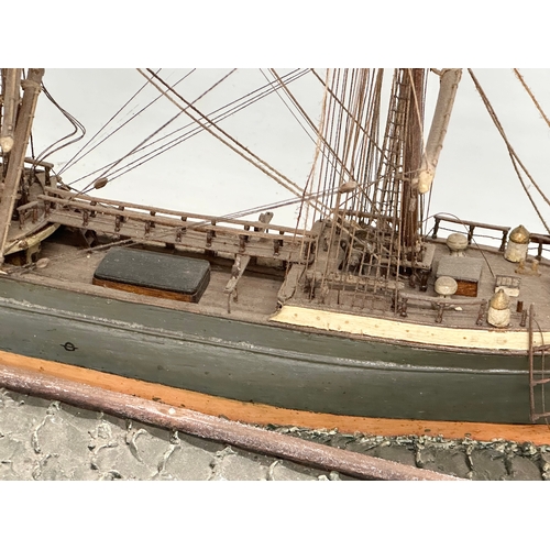 208 - A large 19th Century model ship on display case. 73x30.5x53cm.