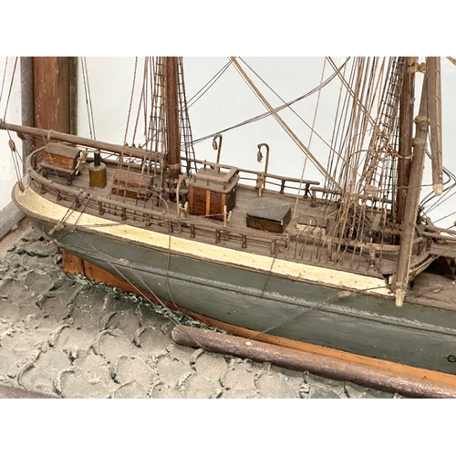 208 - A large 19th Century model ship on display case. 73x30.5x53cm.