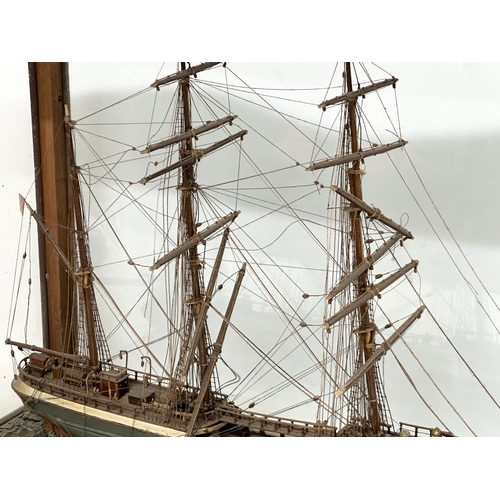 208 - A large 19th Century model ship on display case. 73x30.5x53cm.