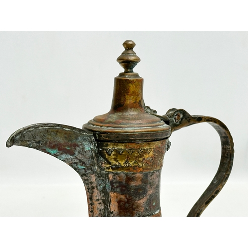 205 - A 18th/Early 19th Century Turkish silvered copper dallah coffee pot with engraved brass banding. 20x... 