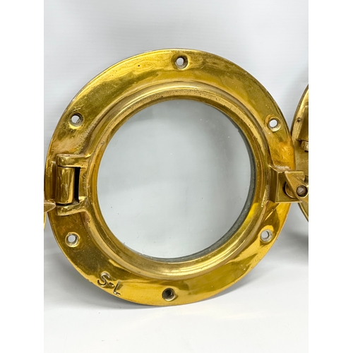 305 - 4 Early 20th Century brass ships portholes. Stamped S-L. Simpson Lawrence. 24cm