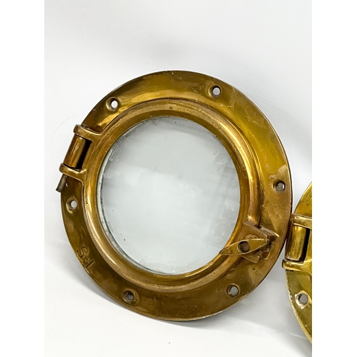 306 - 3 Early 20th Century brass ships portholes. Stamped S-L. Simpson Lawrence. 24cm