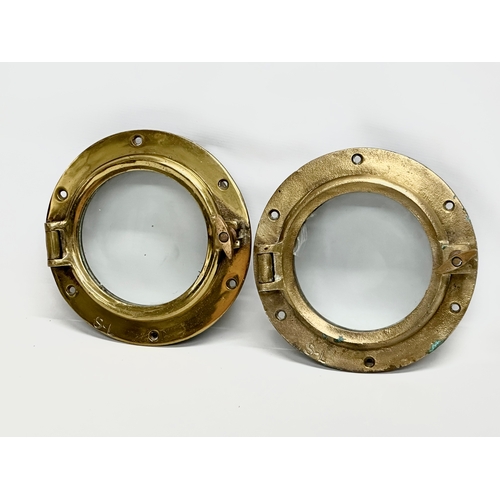 307 - 2 Early 20th Century brass ships portholes. Stamped S-L. Simpson Lawrence. 24cm