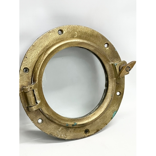 307 - 2 Early 20th Century brass ships portholes. Stamped S-L. Simpson Lawrence. 24cm