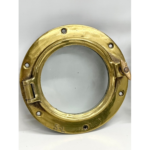 307 - 2 Early 20th Century brass ships portholes. Stamped S-L. Simpson Lawrence. 24cm