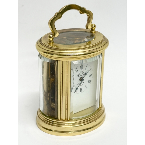 301 - A small L'Epee French brass carriage clock. With key and 5 bevelled glass panels. 9cm.